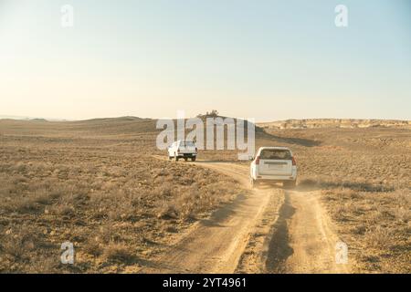 off-road vehicle is driving along the upper Aral Sea. black SUV in the desert. Stock Photo