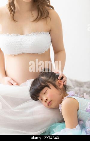 Portrait of pregnant woman and girl in dress Stock Photo