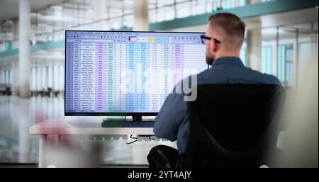 Calculating Electronic Medical Accounts And Codes In A Black Office Using A Spreadsheet On A Computer Screen. Stock Photo