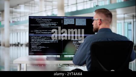 Computer Programmer Writing Program Code On Computer In Office Stock Photo
