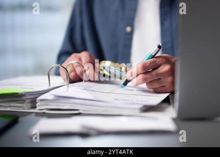 Auditor Using Magnifying Glass For Audit And Fraud Investigation Stock Photo