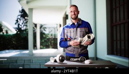 Technician Using Surveillance Security Camera Video System Stock Photo