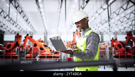 Worker In Automotive Car Factory Using Laptop Stock Photo