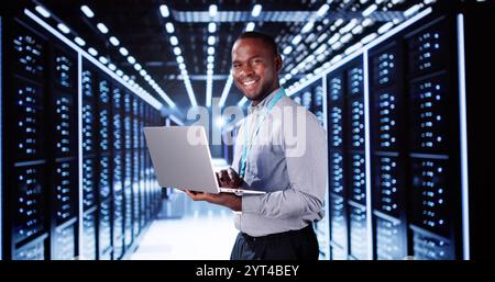 Happy Engineer In Data Center Server Room Configuring AI Technology Stock Photo