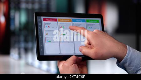 Scrum Project Manager Using Scrum Board Scheduling Software Stock Photo