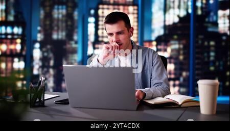 Contemplative Business Analyst With Laptop. Thoughtful Man Pondering Stock Photo