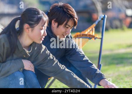 Man and woman roasting marshmallows Stock Photo