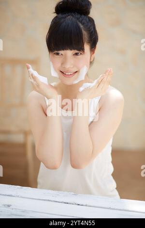 Young woman washing face Stock Photo