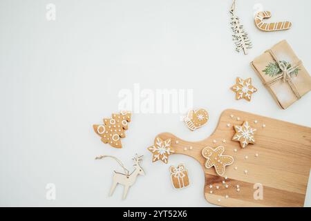 Homemade gingerbread cookies on wooden board with tree decoration. Christmas cookie, winter holidays Stock Photo