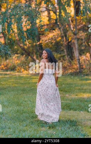 Young model walking in the park looking over her shoulder Stock Photo