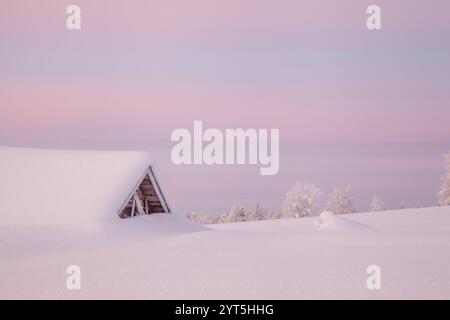 Old red barn in Northern Sweden covered in deep snow Stock Photo