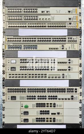Network switches and routers stacked in a data center view showcasing connectivity technology Stock Photo