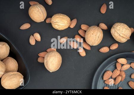 Almonds and walnut flat lay shoot in black background Stock Photo