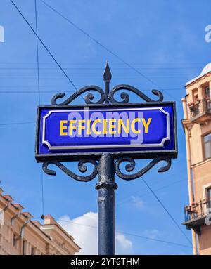 Efficiency symbol. Concept word Efficiency on beautiful blue road sign. Beautiful blue sky and city building background. Business efficiency concept. Stock Photo