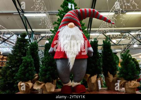 Whimsical Holiday Display of Christmas Gnome Amid Festive Trees Stock Photo