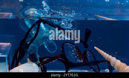Broken glasses in a small aquarium. Stock Photo