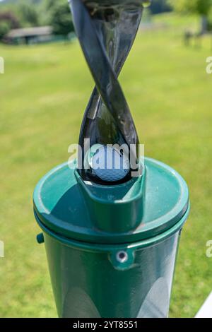 Golf ball station and cleaning machine for dirty bally with blurred background Stock Photo