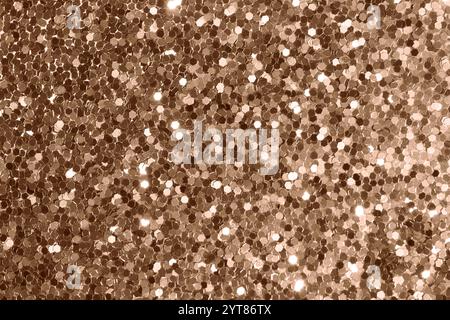 Glittering bronze texture with hexagonal sequins under soft illumination Stock Photo