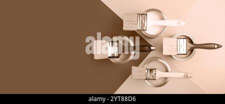 Top view of paint brushes on cans with various shades of brown Stock Photo