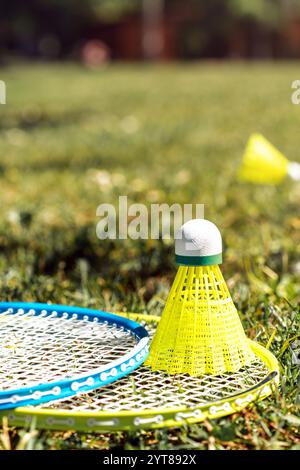 Close-up Badminton shuttlecock and rackets on the green grass. Stock Photo