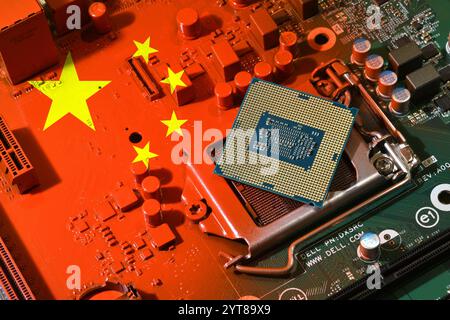 Flag of the Republic of China on a red painted pc motherboard with a CPU. Concept for supremacy in global microchip and semiconductor manufacturing. I Stock Photo