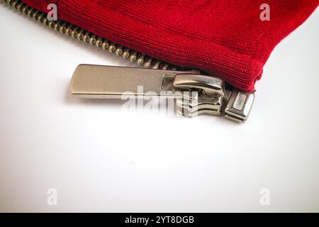 Close-Up of Red Fabric Zipper with Metallic Pull Stock Photo