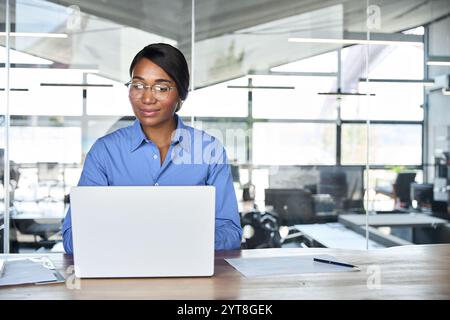 Busy happy business woman executive manager working on computer in office. Stock Photo