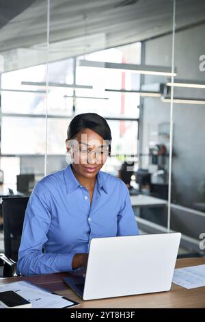 Busy professional business woman executive working on computer in office. Stock Photo