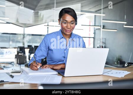 Busy professional business woman executive working on computer in office. Stock Photo