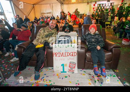 Philadelphia, United States. 06th Dec, 2024. Participants react during Camp Out For Hunger Day Five Friday, December 06, 2024 in Philadelphia, Pennsylvania Camp Out For Hunger is a week long event and live broadcast by radio station WMMR to benefit Philabundance as they take donations for the less fortunate. It is the largest food single location drop off food gathering charity in the United States. Credit: William Thomas Cain/Alamy Live News Stock Photo