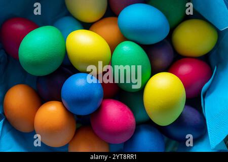 Detail shot of some colorful easter eggs in a basket seen from above Stock Photo