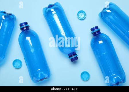 Plastic bottles and caps on light background, top view Stock Photo