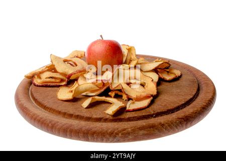 Apple rings with an apple on a wooden board Stock Photo