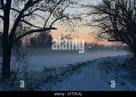Sunset in the Amper valley and fog over snow-covered fields, Moosburg, Upper Bavaria Stock Photo