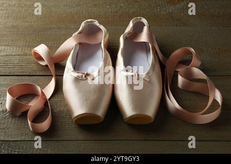 Pair of beautiful pointe shoes on wooden table Stock Photo