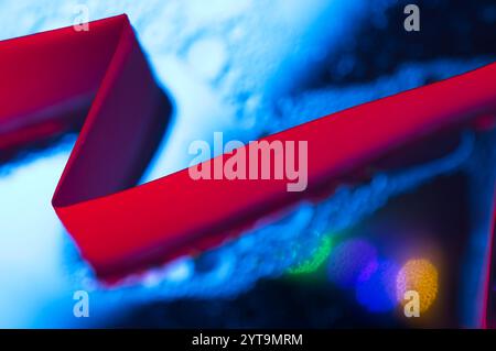 Red ribbon of light streaking through abstract background of blue Stock Photo