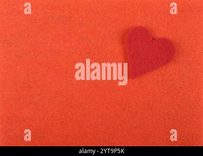 Felt heart on a red background Stock Photo