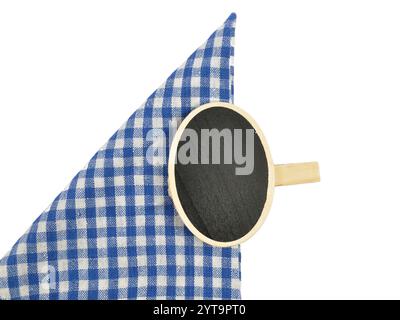 Board with wooden clip on checkered cloth Stock Photo