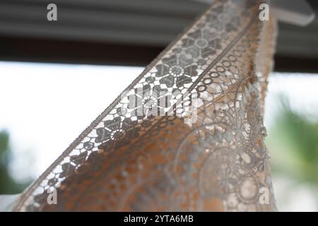 Wedding dress made of lace and silk. Detail shot of an elaborate textile pattern with transparency. Wedding background. Stock Photo