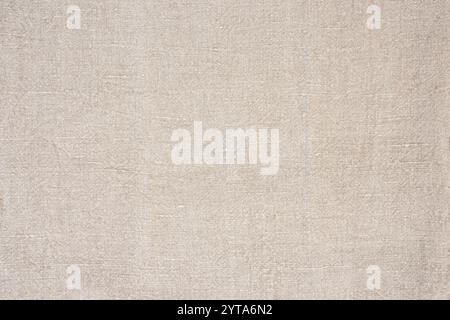 Natural beige colored linen texture. Linen fabric on top view. Background for weddings in boho style with space for text. Stock Photo