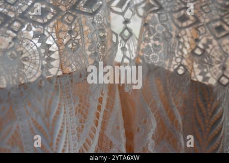 Wedding dress made of lace and silk. Detail shot of an elaborate textile pattern with transparency. Wedding background. Stock Photo