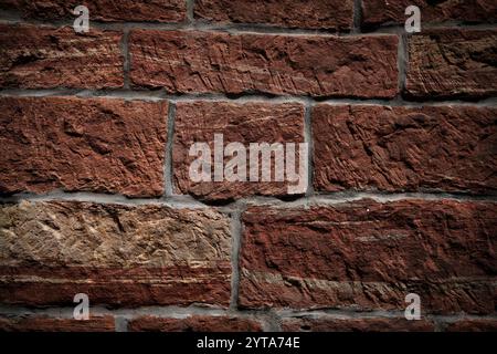 Background with rustic old stone wall pattern. Rough warm sand stone texture. Close-up. Stock Photo