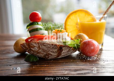 Healthy breakfast with freshly squeezed orange juice and colorful eggs on rustic wooden table. Close-up with short depth of field. Stock Photo