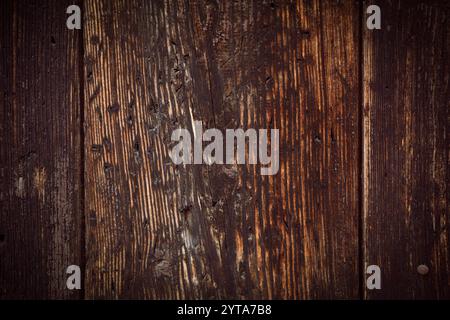 Background of old vertical dark wooden planks. Weathered wooden structure. Stock Photo