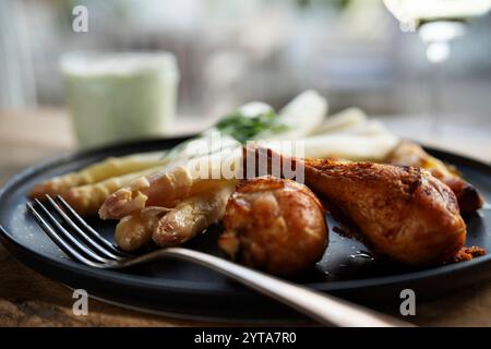 Fresh white asparagus with crispy chicken legs. Background for healthy eating concept with space for text. Stock Photo