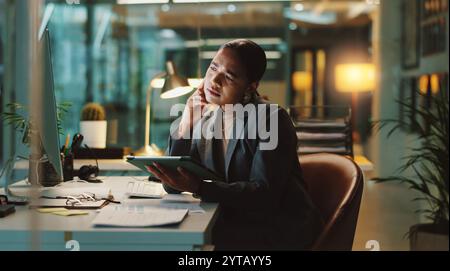 Woman, confused and tablet in office for business, network error and thinking of finance mistake at night. Accountant, tech and stress for deadline Stock Photo