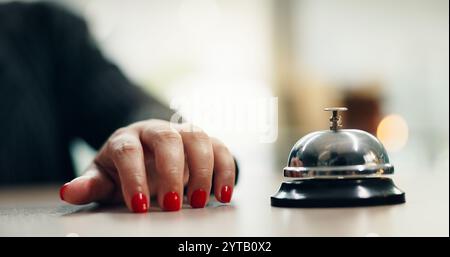 Hands, bell and woman at hotel reception with attention for customer support and concierge help. Hospitality, check in and lobby with front desk Stock Photo