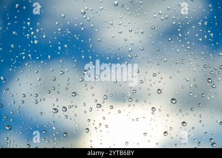 Rain drops on the glass. Beautiful blue and white sky sunshine Stock Photo