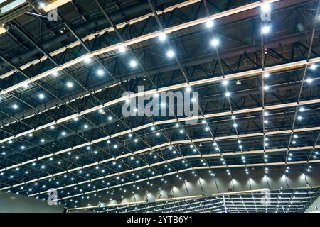 Scattered dot directional led lights on rails under the ceiling in a modern large public space warehouse, shopping center building, office or other co Stock Photo