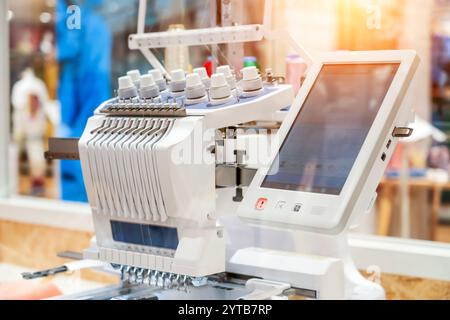Threads on a sewing machine in loops from spools during automatic operation Stock Photo